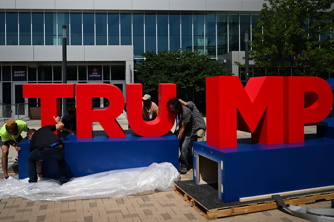 Carpenters assemble a Trump 2024 sign outside the Fiserv Forum in Milwaukee, Wisconsin, on July 13, ahead of the 2024 Republican National Convention. 