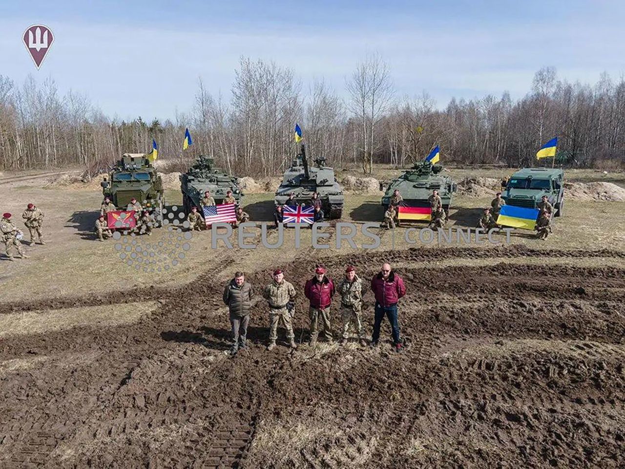 Ukraine's Defence Minister Oleksii Reznikov and Commander of the Air Assault Forces Maksym Myrhorodskyi pose for a picture in front of?British?Challenged 2 main battle?tank, US Stryker and Cougar armoured personnel carriers and German Marder infantry fighting vehicle in an unknown location in?Ukraine, in this handout picture released Monday, March 27.
