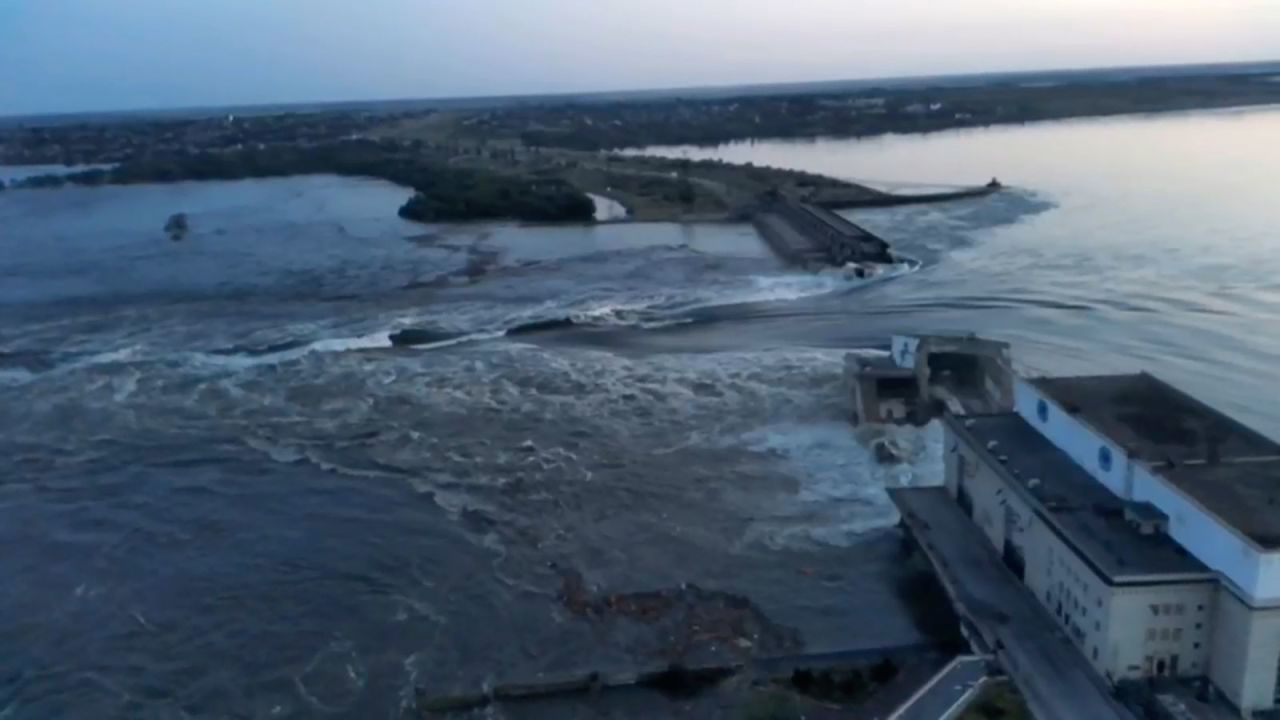 A frame from a video shared on social media shows water gushing from the breach in the dam on Tuesday, June 6. 