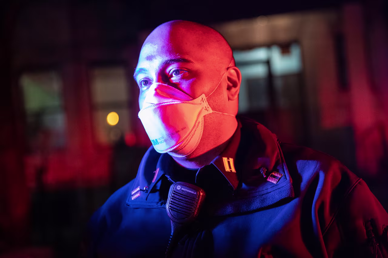 EMS Capt. AJ Briones looks upon an emergency scene as EMTs load a presumptive Covid-19 patient into an ambulance on April 22, in Yonkers, New York.