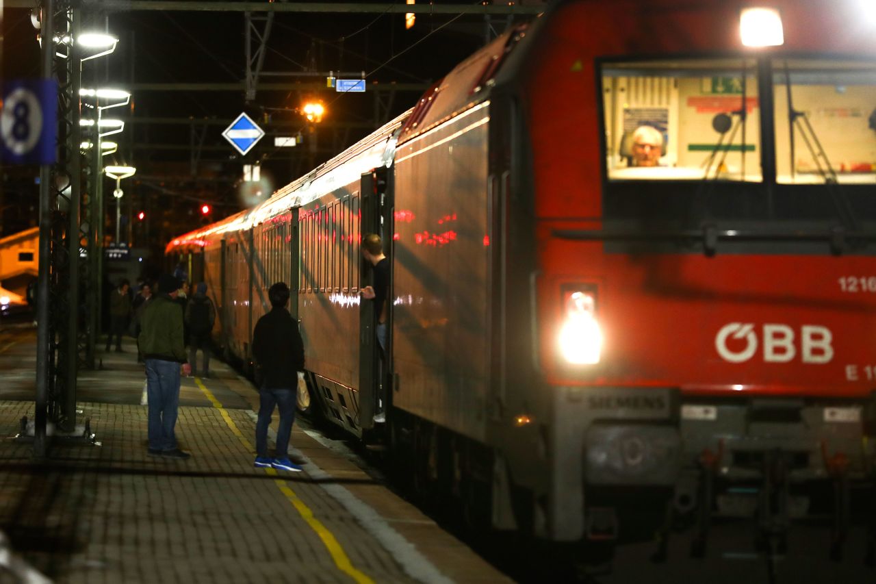 People stand on the platform next to the train stopped by authorities on the Italian side of Brenner Pass, Sunday.