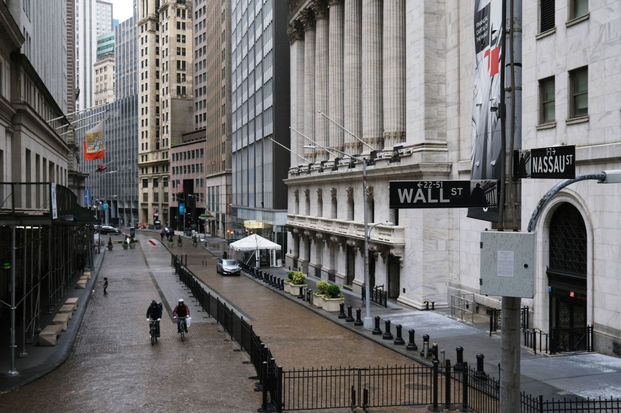 People walk across from the New York Stock Exchange on May 8 in New York City. 