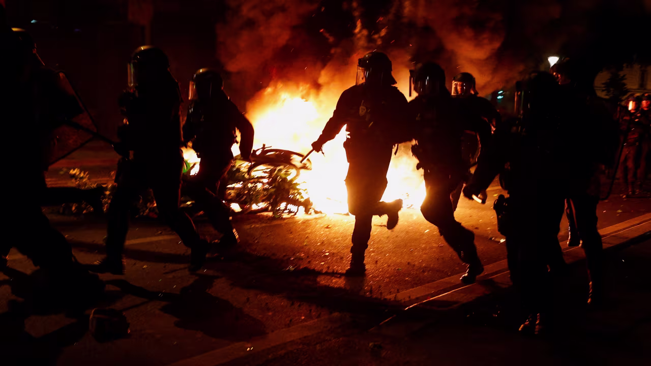 French riot police run during clashes with demonstrators at the Place de la République in Paris on July 7. 