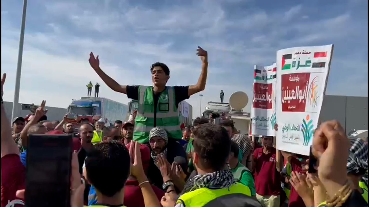 Aid workers celebrate after the brief opening of the Rafah crossing on Saturday.