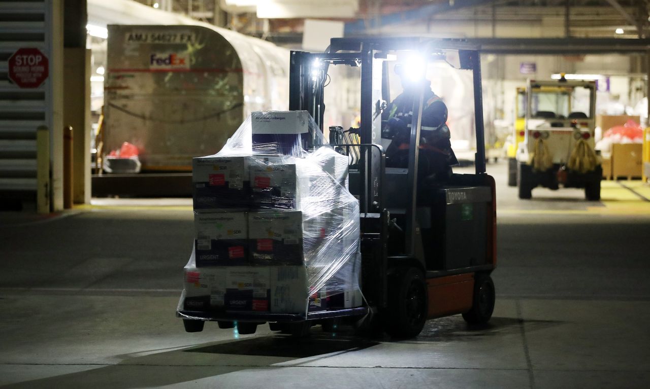 A skid of Moderna COVID-19 vaccines are moved on the tarmac at Pearson International Airport in Toronto, Ontario, on April 3. 