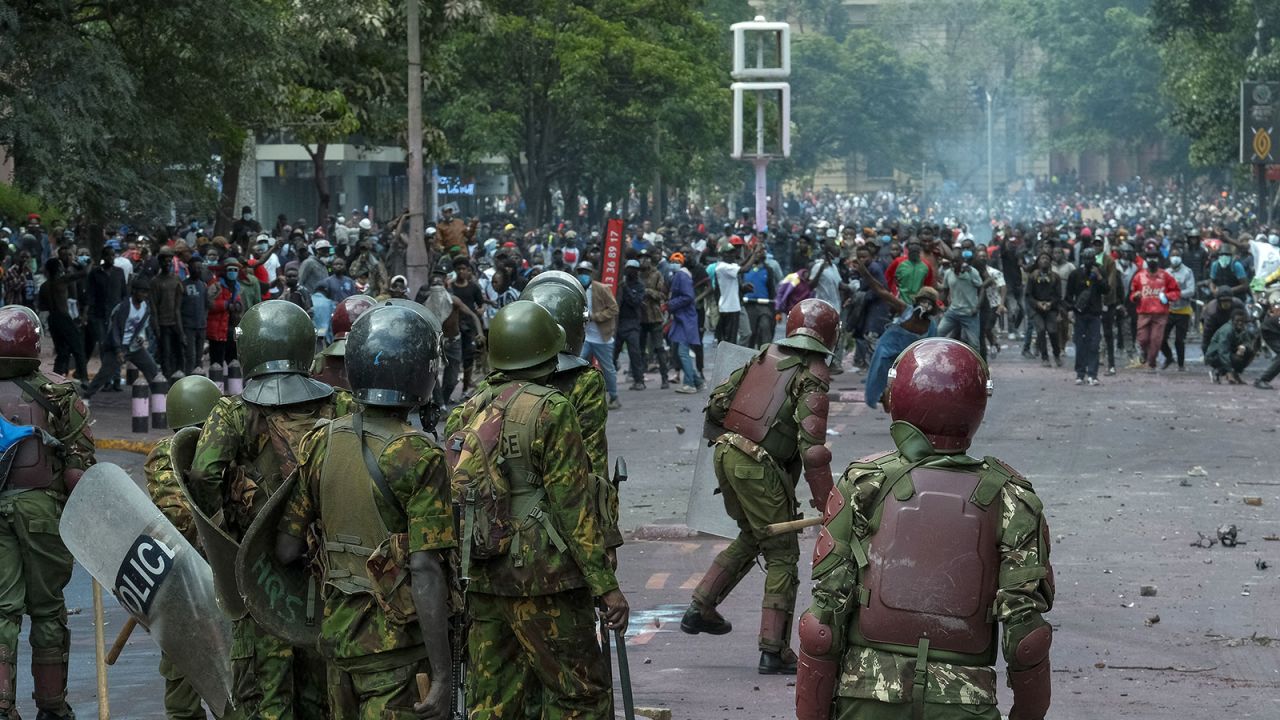 Demonstrators hurl stones at Kenyan security forces during a protest in downtown Nairobi, on Tuesday, June 25. 