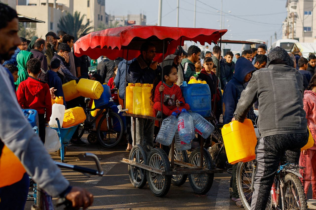 Palestinians wait to collect drinking water in Rafah, Gaza, on January 9.