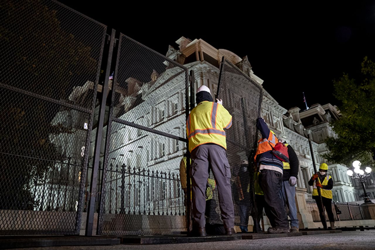 Construction workers set up additional fencing near the White House in Washington, D.C., U.S., on Monday, Nov. 2, 2020. 