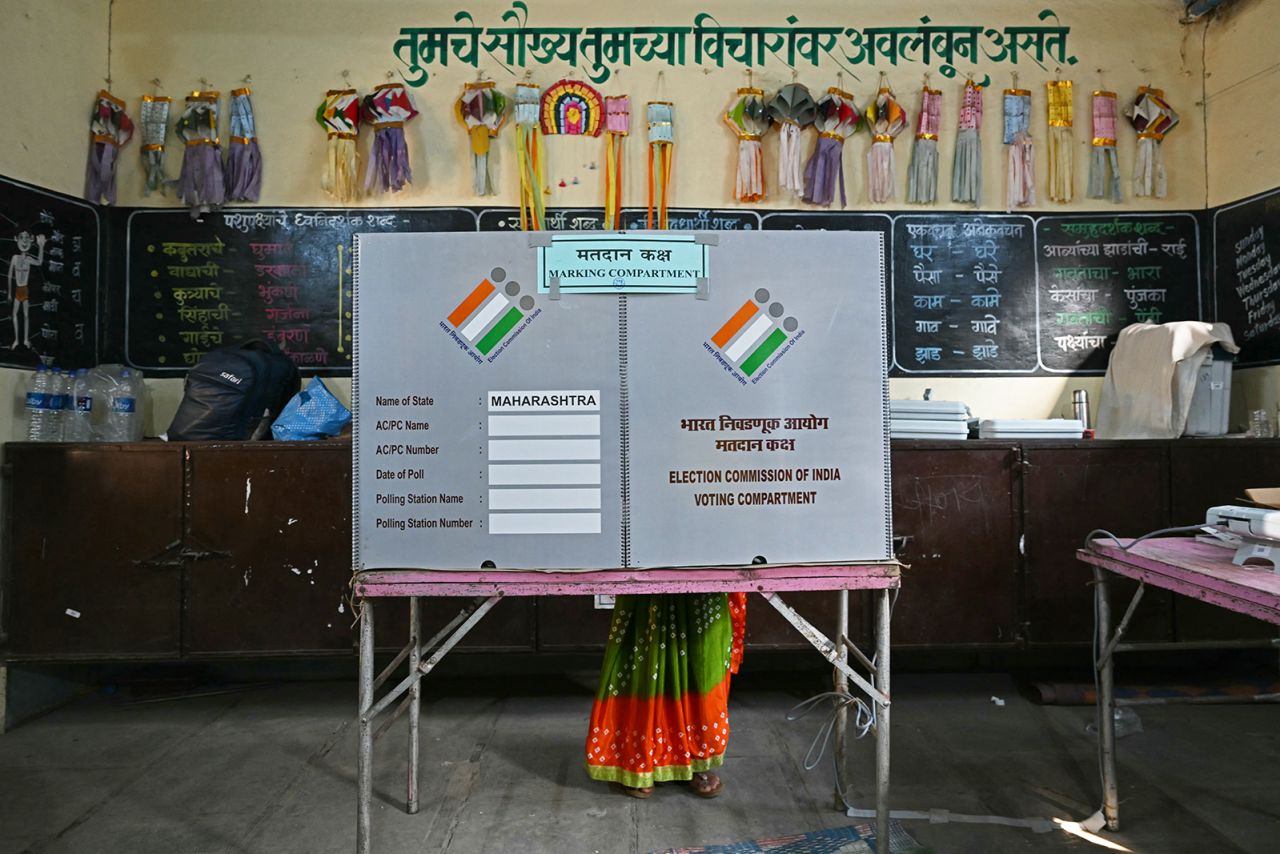 A voter casts her ballot at a polling station during the fourth phase of voting in India's general election, in Karjat of Maharashtra state on May 13.