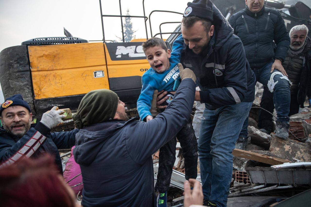 Cakmak is passed across the rubble by a chain of rescuers.