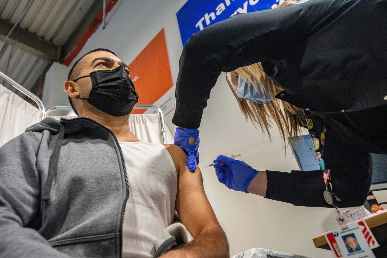 Otto Delcid is inoculated with the Pfizer-BioNTech Covid-19 vaccine by nurse Nicole Colon at the UMass Memorial Health Care COVID-19 Vaccination Center in the Mercantile Center in Worcester, Massachusetts, on April 22.