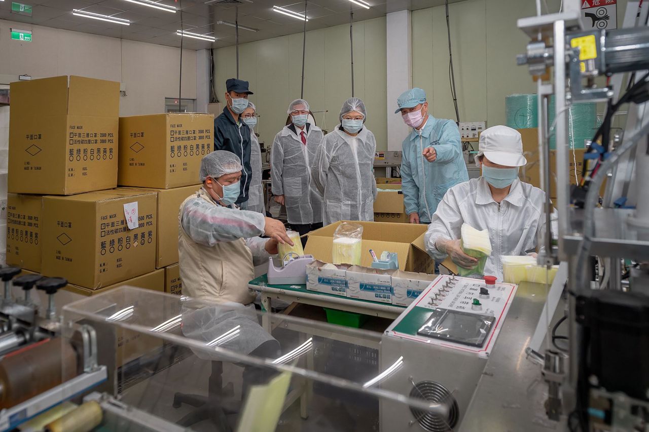 A handout photo made available by the Taiwan Presidential Office shows Taiwan's President Tsai Ing-wen, center, during an inspection at a face masks factory in New Taipei, Taiwan on February 5.