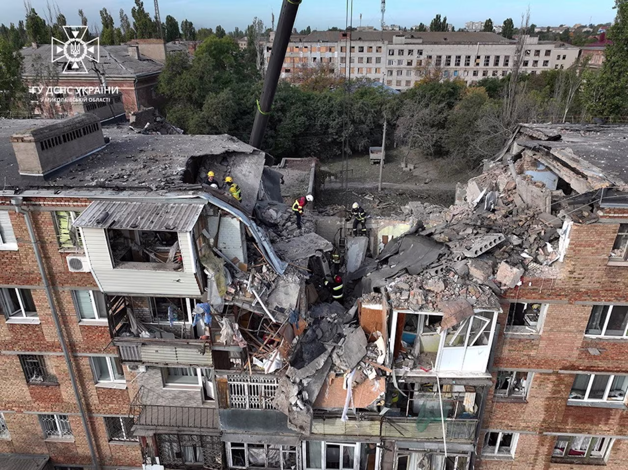 Rescuers work at the site of a residential building heavily damaged during a Russian military attack in Mykolaiv on October 13.