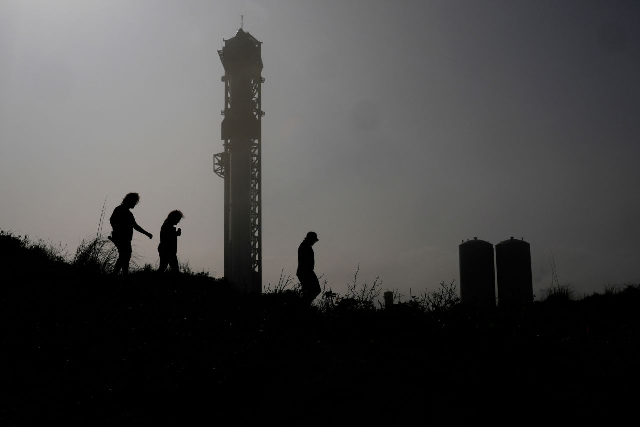 Visitors watch SpaceX's rocket Starship being prepared for its third test flight from Starbase in Boca Chica, Texas, on March 13.