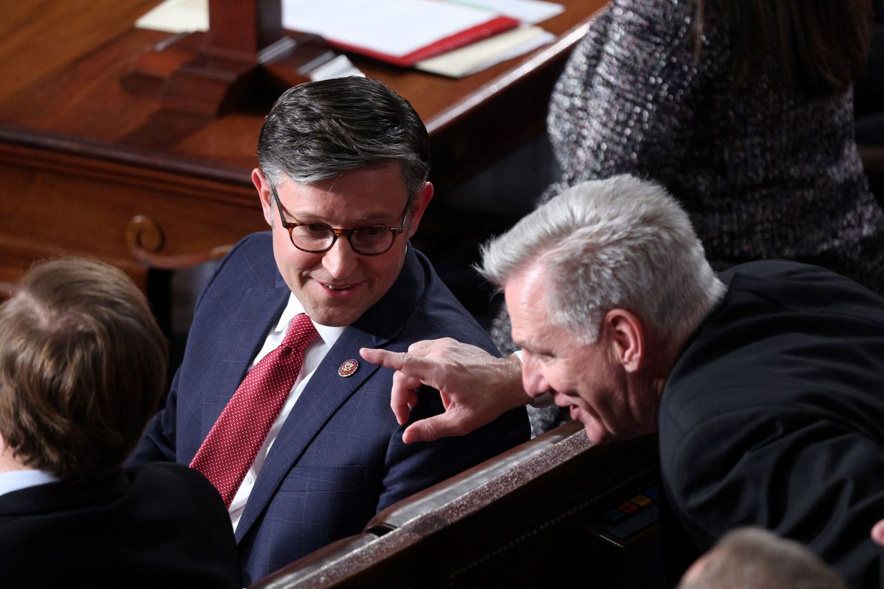 Rep. Mike Johnson talks with Rep. Kevin McCarthy on the House floor before the fourth vote to elect a new House Speaker at the Capitol in Washington, DC on October 25, 2023. 