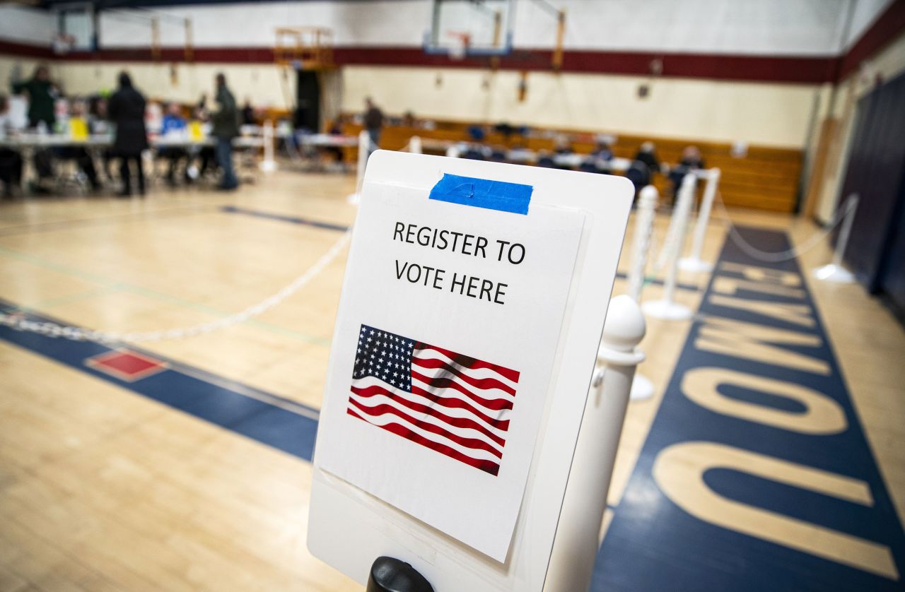 A sign to register to vote at a polling station inside Plymouth Elementary School in Plymouth, New Hampshire, on January 23.