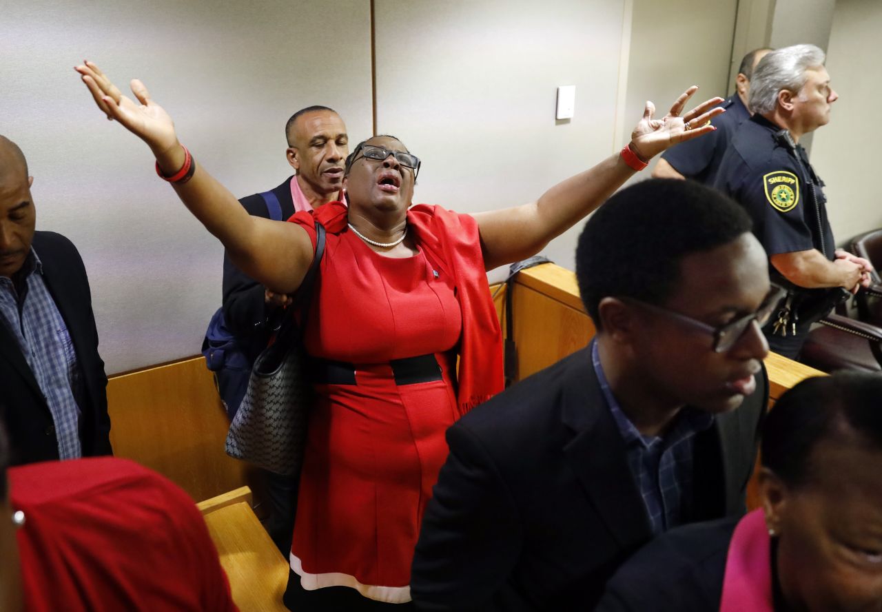 Botham Jean's mother, Allison Jean, raises her arms in the court after former Dallas police officer Amber Guyger is found guilty of murder on Oct. 1, 2019 in Dallas. 