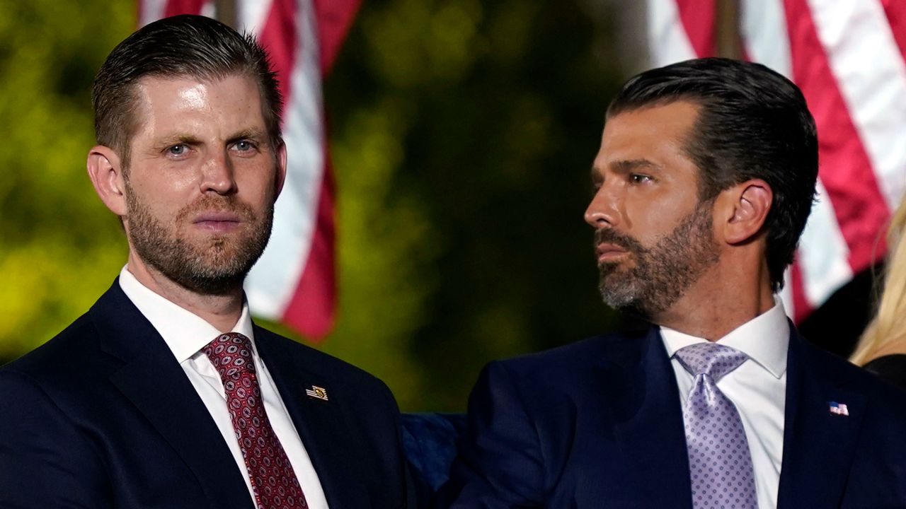 Eric Trump, left, and Donald Trump Jr. wait for their father to speak at the White House in 2020.