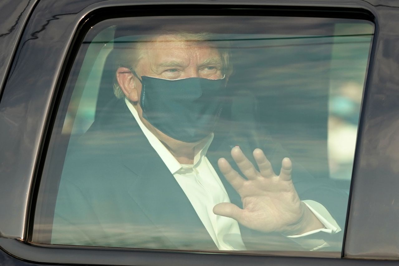 President Donald Trump waves to supporters outside of Walter Reed Medical Center on October 4 in Bethesda, Maryland