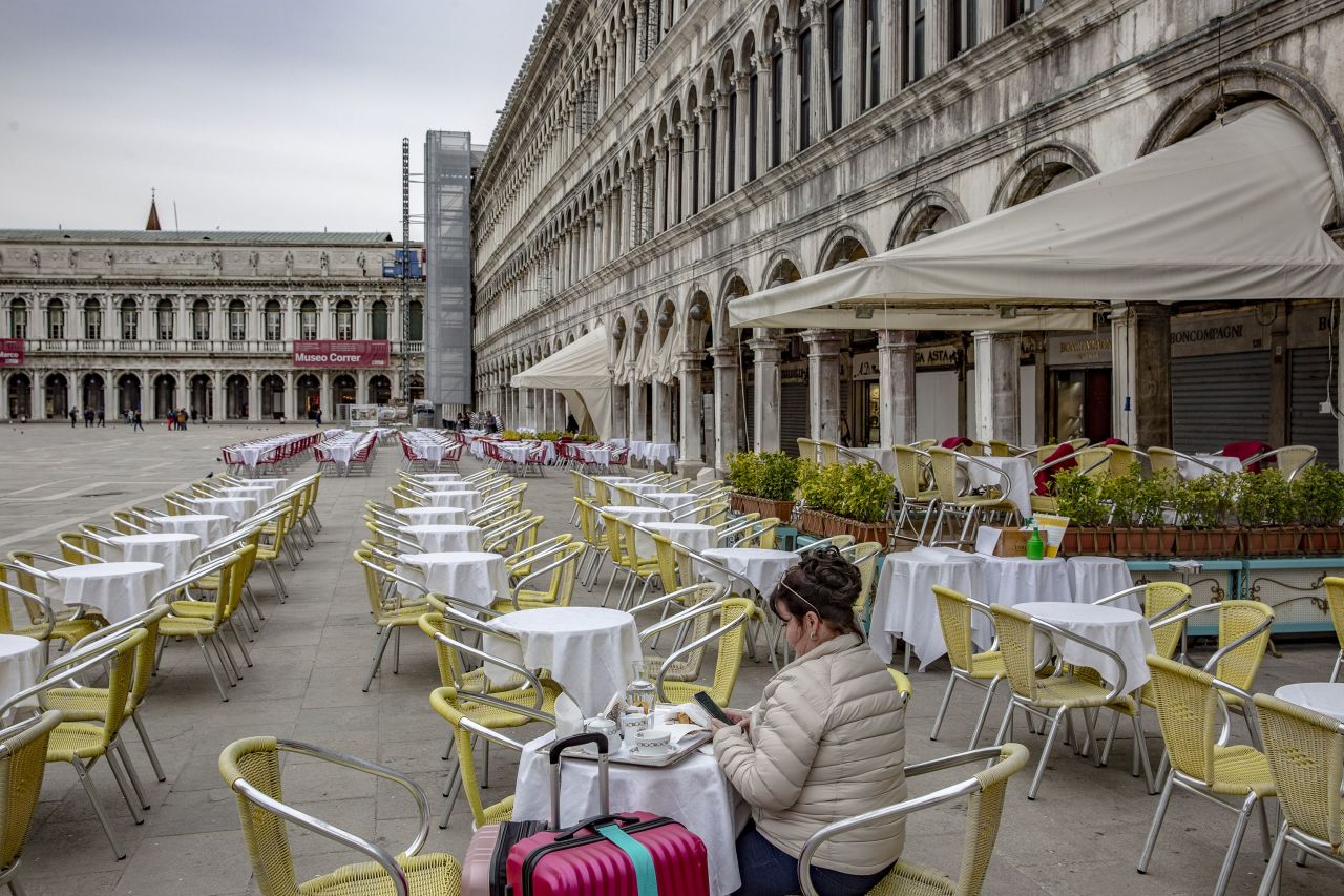 A tourist sits at a restaurant in San Marco Square in Venice, Italy, on Thursday, March 5.