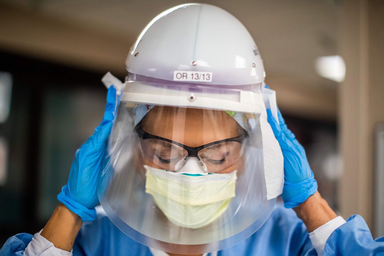 Registered nurse Carmen Verano wipes her CAPR helmet after attending to a Covid-19 patient in the Intensive Care Unit at Providence Cedars-Sinai Tarzana Medical Center in Tarzana, California on December 18.