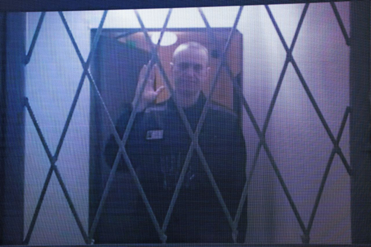 Jailed Russian opposition figure Alexey Navalny is seen on a screen via a video link from the IK-3 penal colony during a hearing of his complaint on restrictions placed on which books and reading material he can access in prison, at the Supreme Court in Moscow, Russia, on January 11.