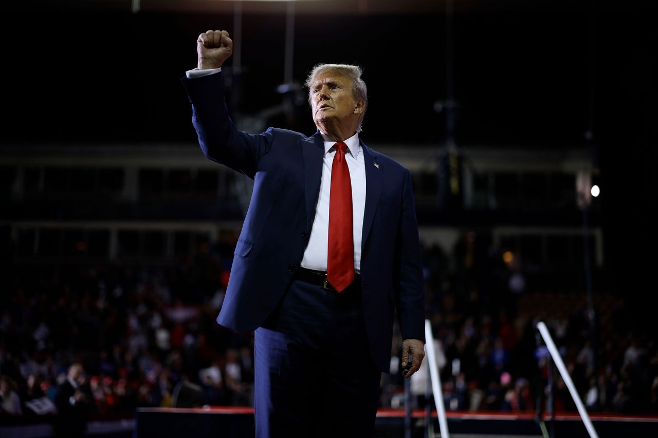 Former President Donald Trump acknowledges supporters as he leaves the stage at a campaign rally on January 20 in Manchester, New Hampshire. 