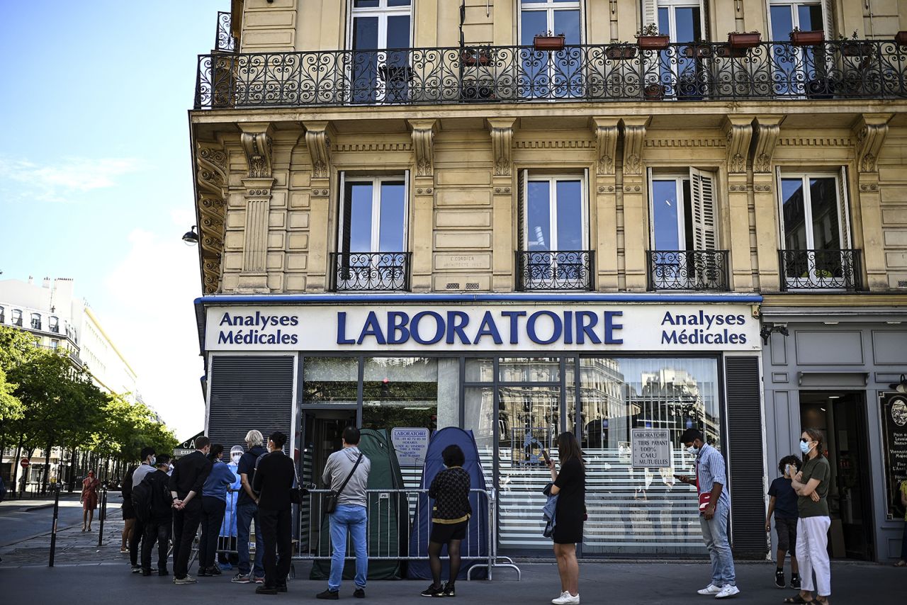 People stand in a queue as they wait for a PCR test for the novel coronavirus at a medical laboratory in Paris amids the Covid-19 pandemic on September 4.