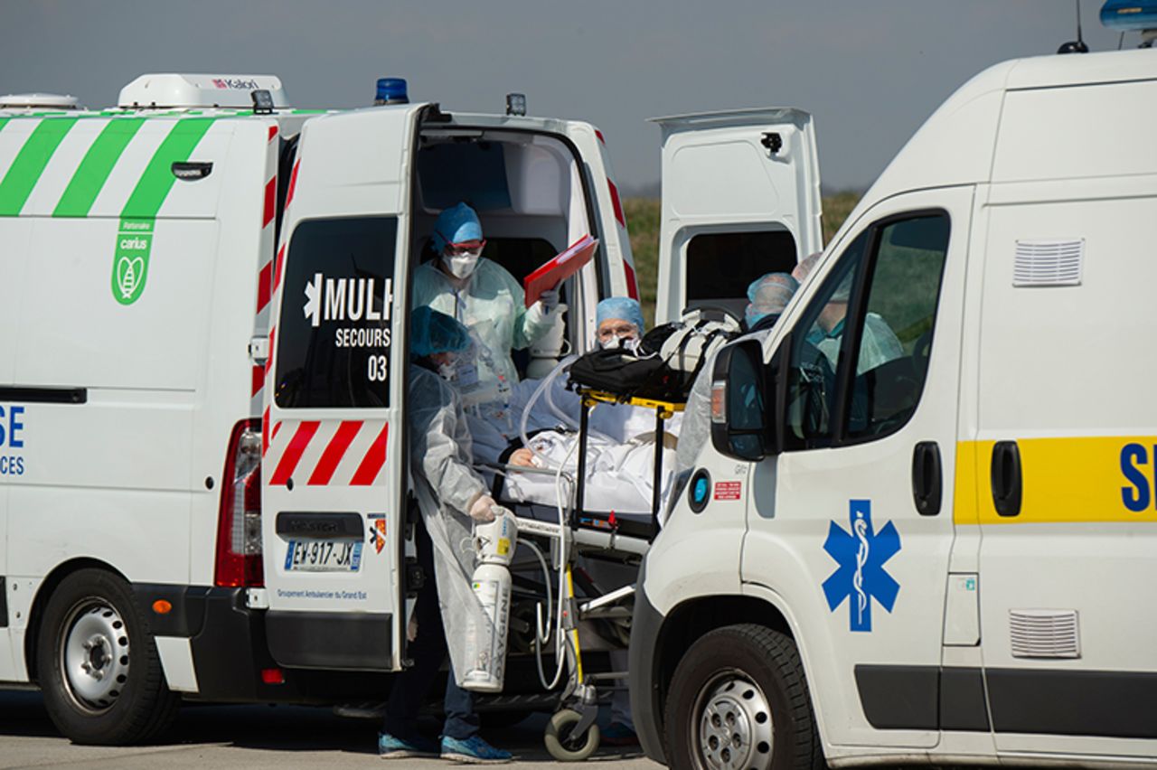 This photo provided by the French Army shows military doctors and rescue workers pulling a patient out of an ambulance in Mulhouse, eastern France, a region hardly hit by the coronavirus pandemic, before flying to southern France Wednesday, March 18.