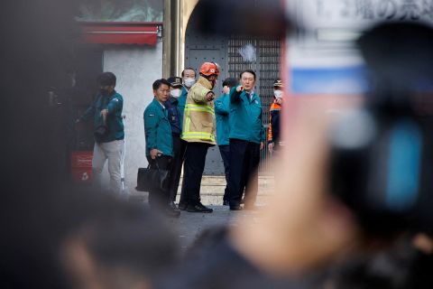 South Korean President walks at the scene with emergency personnel in Seoul on October 30.