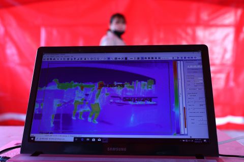 A fan walks past a thermal camera used to look for signs of the coronavirus ahead of the AFC Champions League Group E match between FC Seoul and Melbourne Victory at the Seoul World Cup Stadium on Tuesday, February 18, 2020 in Seoul, South Korea.