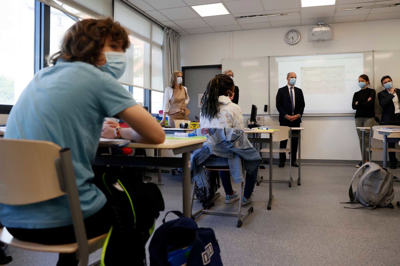 French Education and Youth Affairs Minister Jean-Michel Blanquer, center, visits a middle school in Boulogne-Billancourt, France, as primary and middle schools reopen on June 22.
