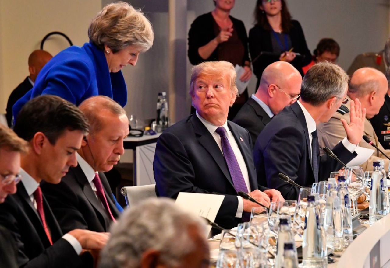 President Donald Trump looks at British Prime Minister Theresa May during a dinner of leaders at the Art and History Museum at the Park Cinquantenaire in Brussels on July 11, 2018. 