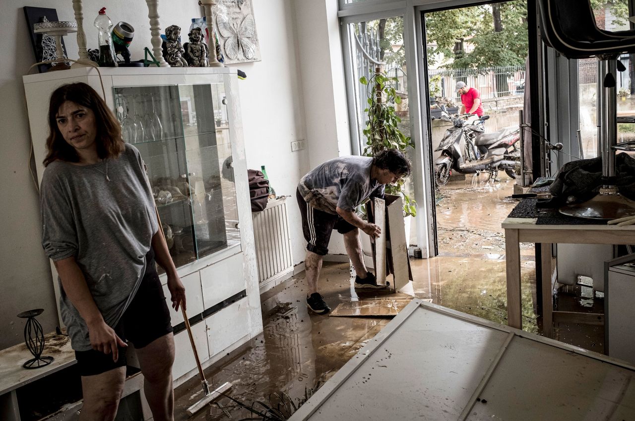 Homeowners push mud and water out of their house after flooding in Angleur, Belgium, on Friday July 16, 2021. 