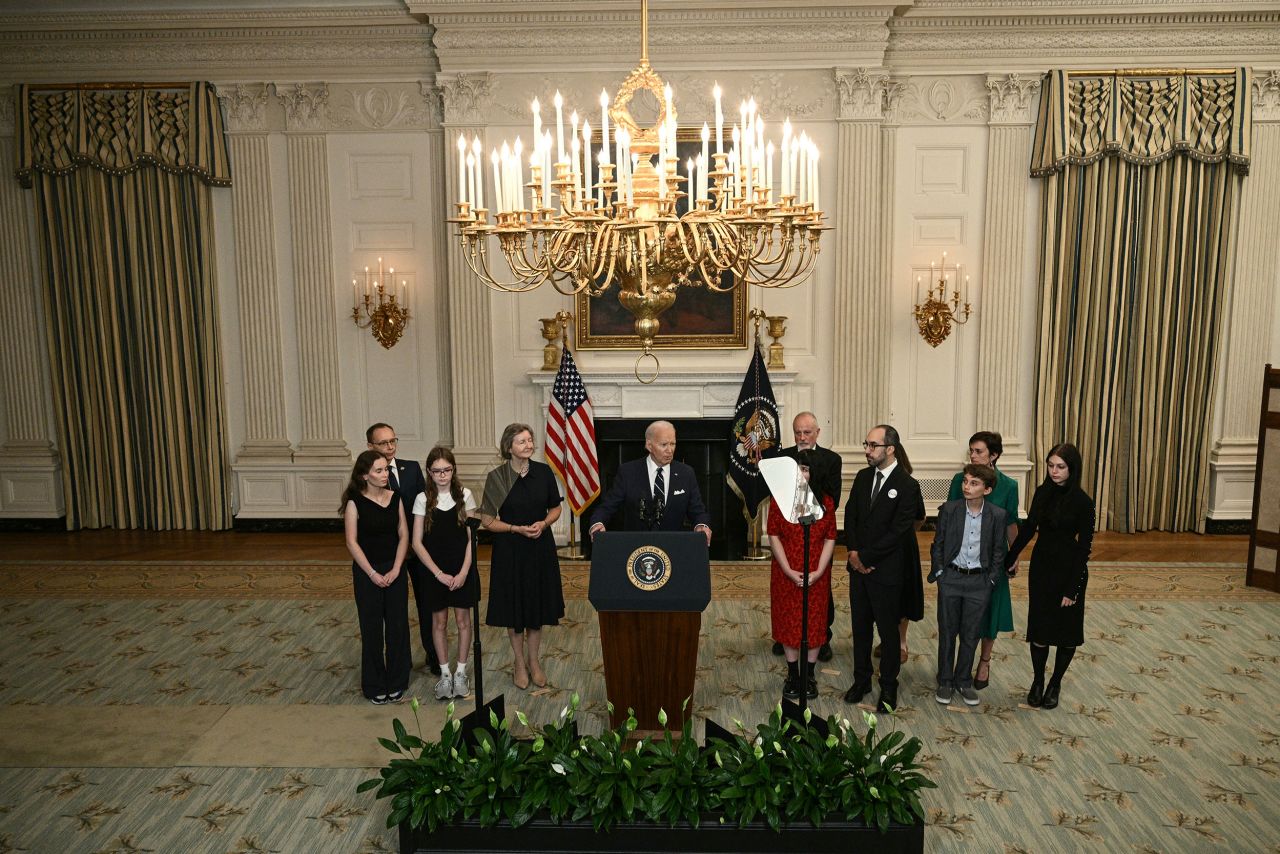 US President Joe Biden, standing alongside family members of the freed prisoners, speaks about the prisoner exchange with Russia, in the State Dining Room of the White House in Washington, DC, on August 1.