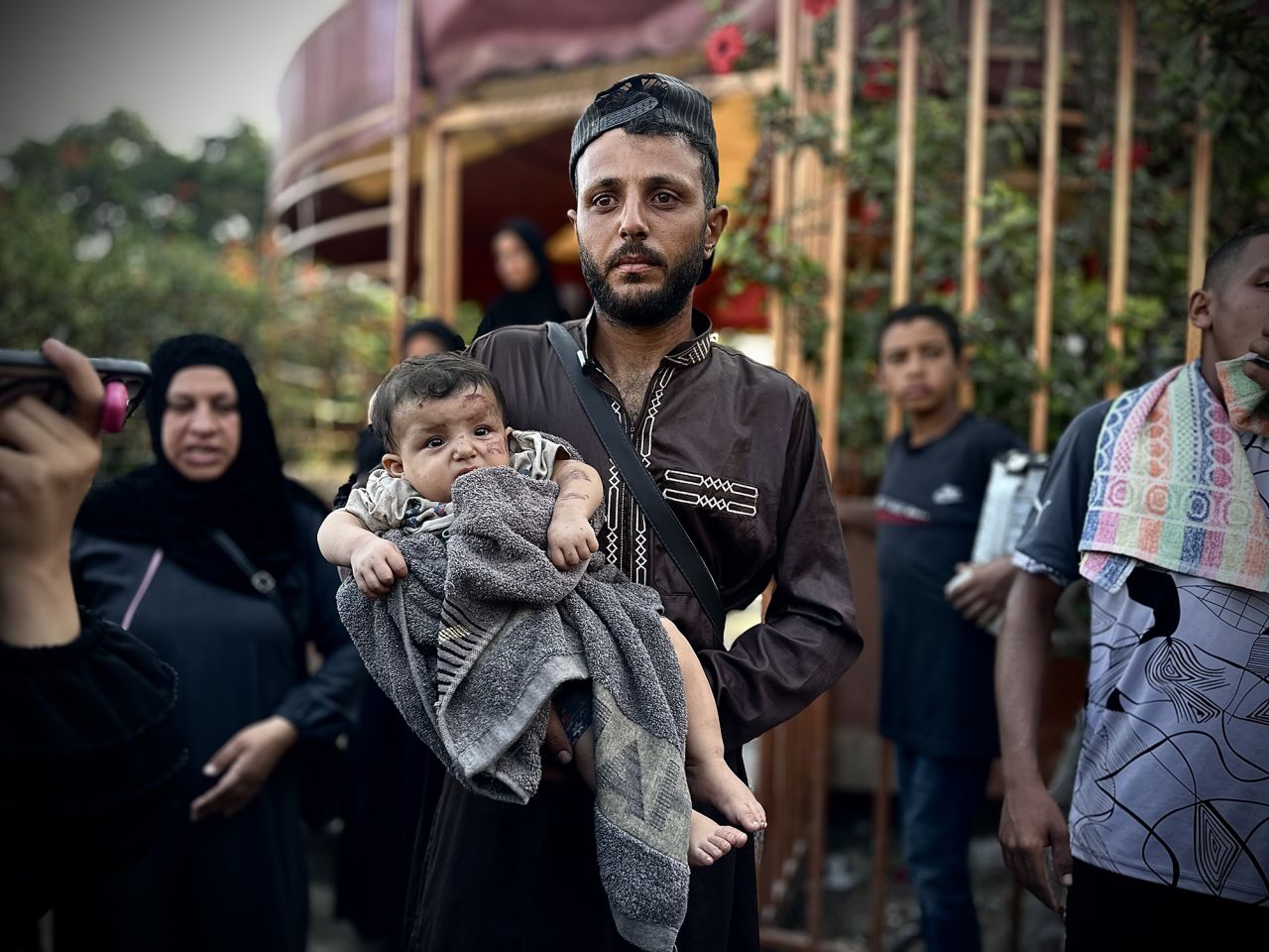 A man holds an injured child outside Nasser Hospital after Israeli airstrikes hit a refugee camp in Khan Younis, Gaza, on September 10.