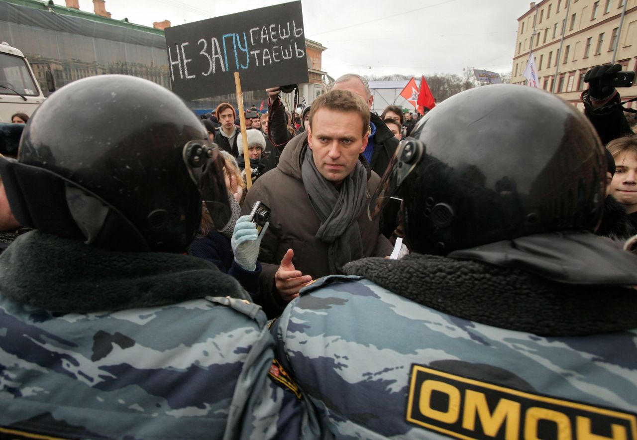 Alexey Navalny speaks with riot police officers blocking the way during a massive protest rally against Prime Minister Vladimir Putin's rule in St. Petersburg, Russia, in 2012.