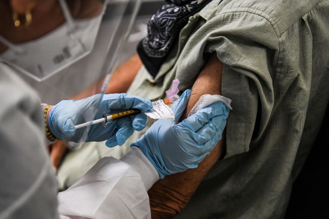 A person receives an injection while taking part in a vaccine trial at the Research Centers of America in Hollywood, Florida, on August 13.