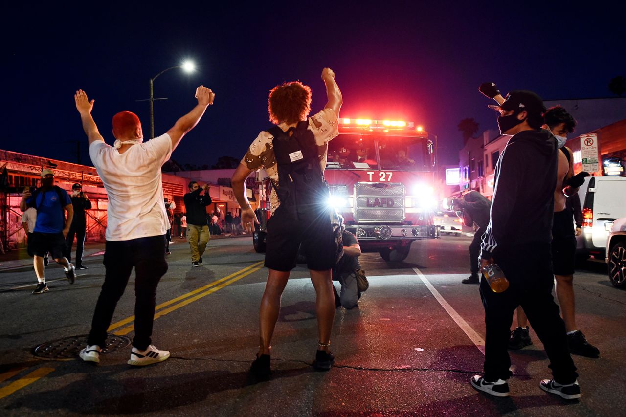 Demonstrators block the path of a Los Angeles Fire Department truck on Melrose Avenue on Saturday, May 30.