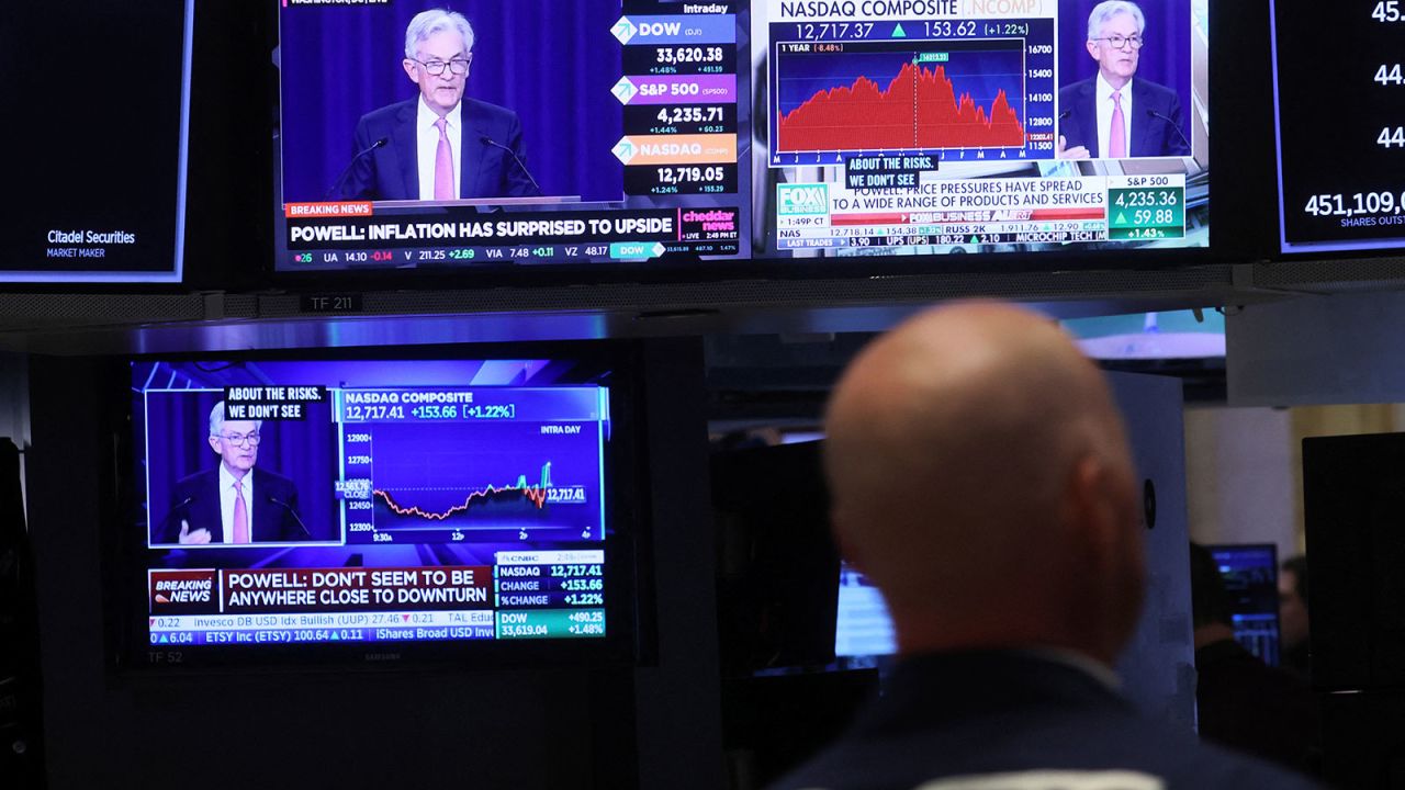 A trader works, as Federal Reserve Chair Jerome Powell is seen delivering remarks on screens, on the floor of the New York Stock Exchange in New York City on May 4.
