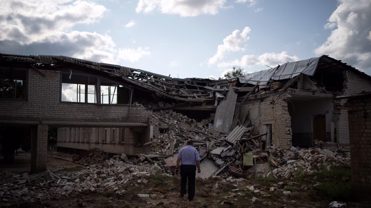 Oleksandr Pishchyk, a school director, stands in front of the school library that was destroyed by shelling in Kupiansk, Ukraine, on Wednesday, August 23.
