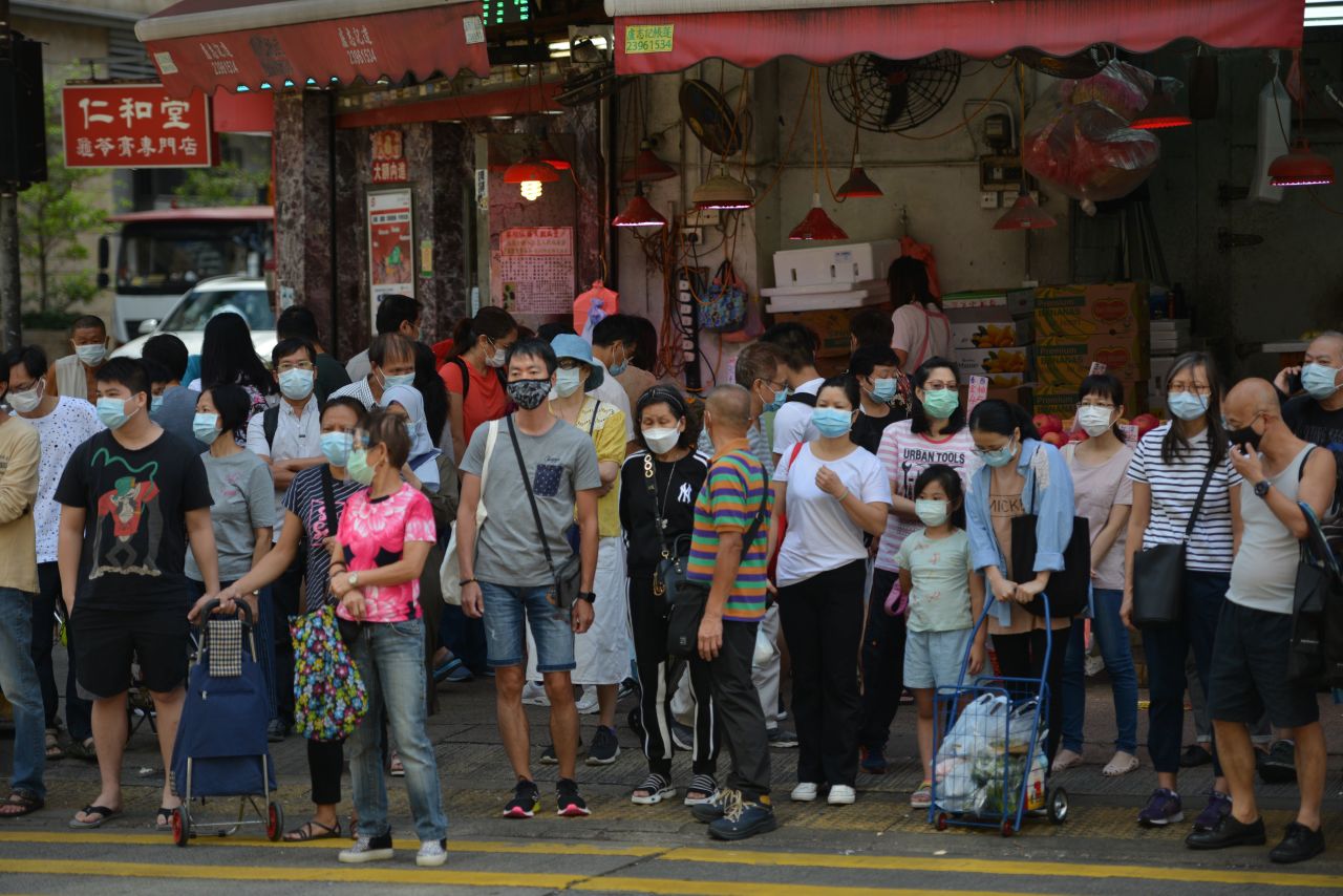 People in Hong Kong wait to cross a road on October 18.