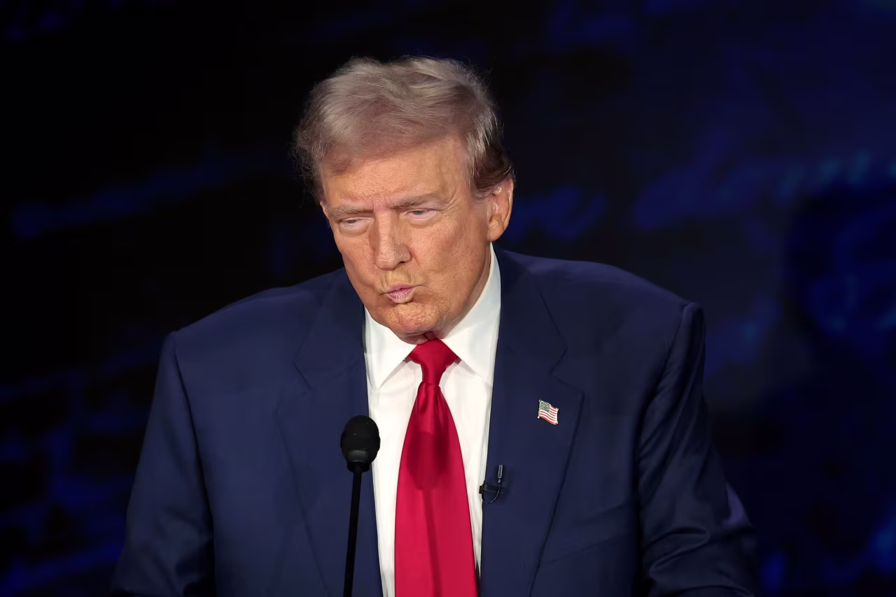 Trump reacts during the debate.