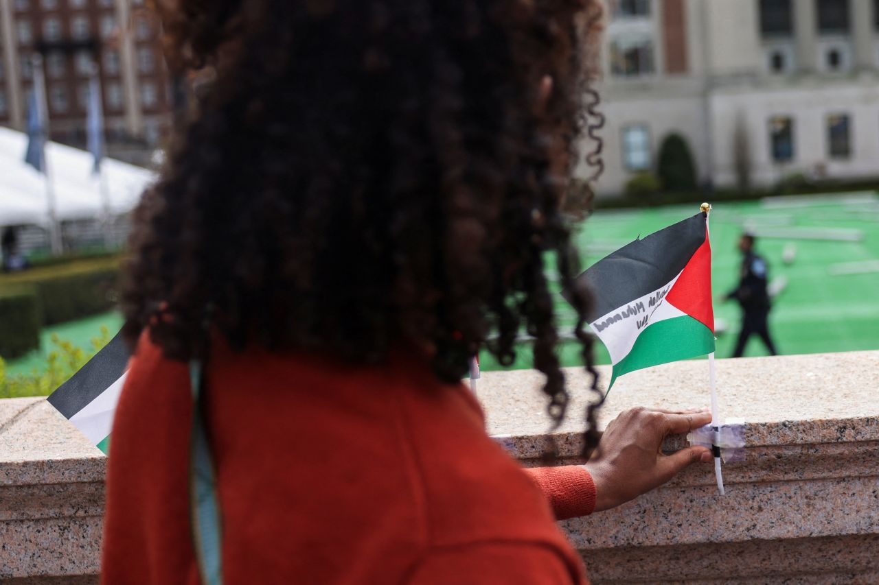 A student secures a Palestinian flag near a protest encampment on the main campus of?Columbia?University in New York City on April 27. 