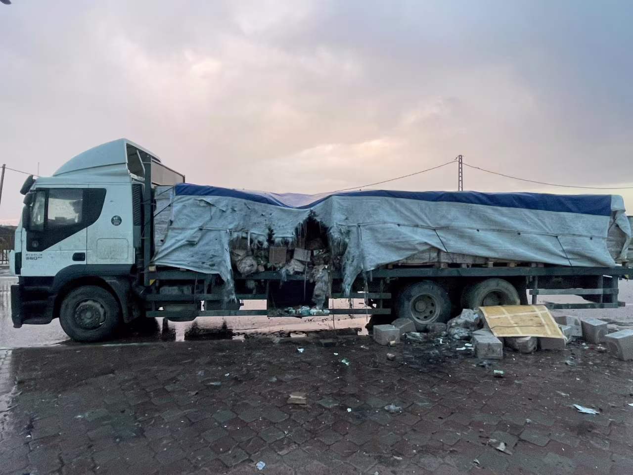 A view of a truck carrying food that, according to Thomas White, Director of UNRWA Affairs Gaza, was hit by Israeli naval gunfire, in this picture obtained from social media on February 5.