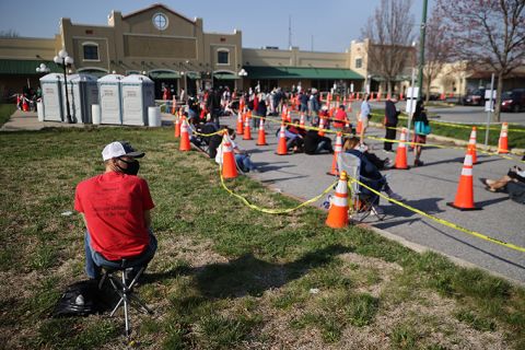 Hundreds of people without appointments stand in line outside the mass coronavirus vaccination site at Hagerstown Premium Outlets on April 07, in Hagerstown, Maryland. 