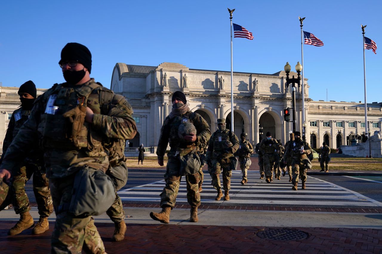 Members of the National Guard walk from Union Station to the Capitol in Washington, DC, as events get under way for Joe Biden's inauguration ceremony on January 20.