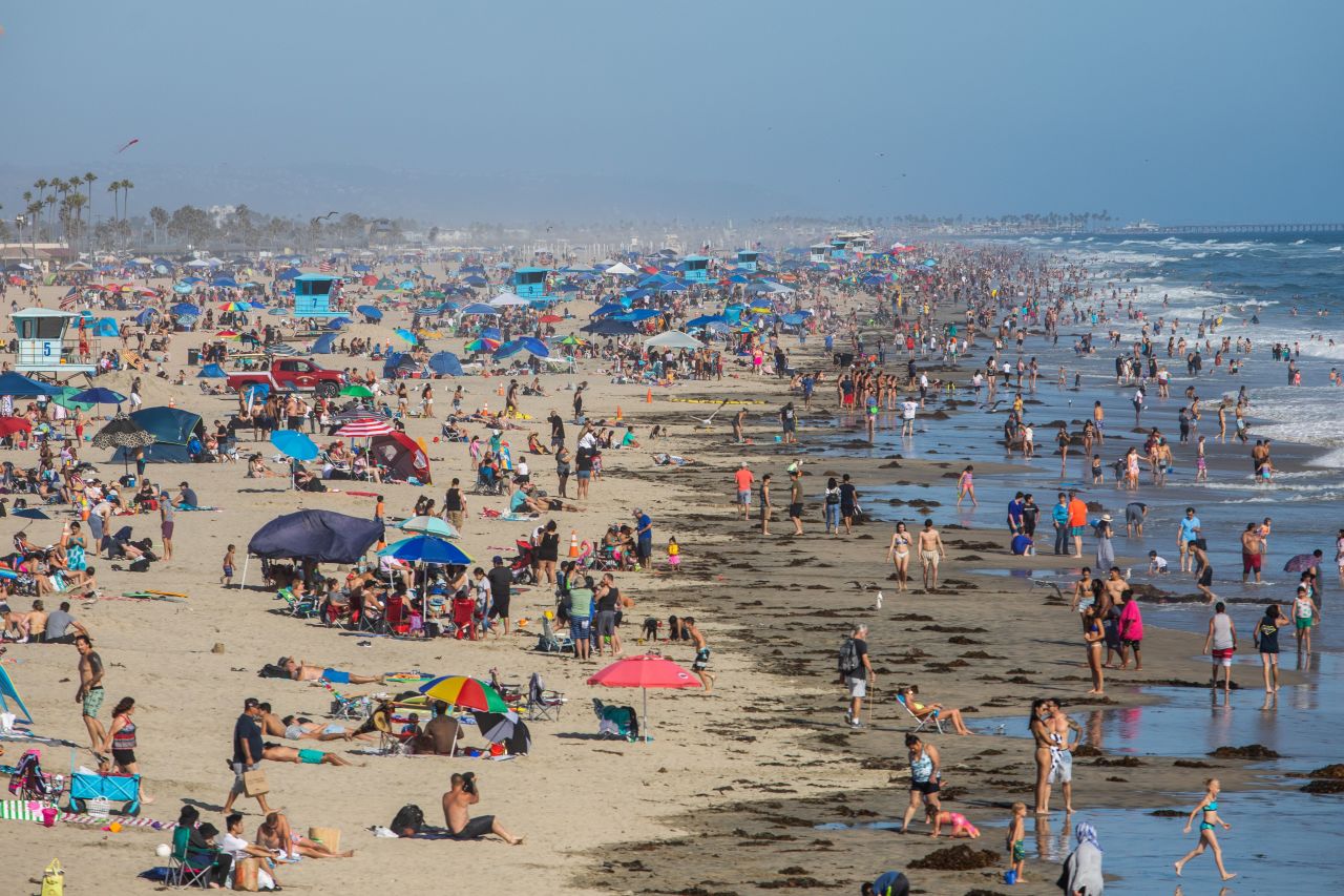 People enjoy the beach in Huntington Beach, California, on June 14.