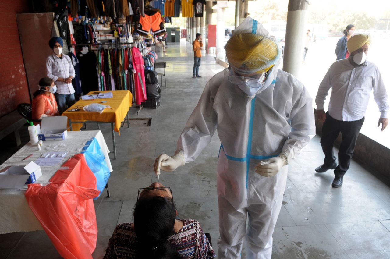 A health worker collects a swab sample from a person for Covid-19 testing on March 27 in Chandigarh, India.