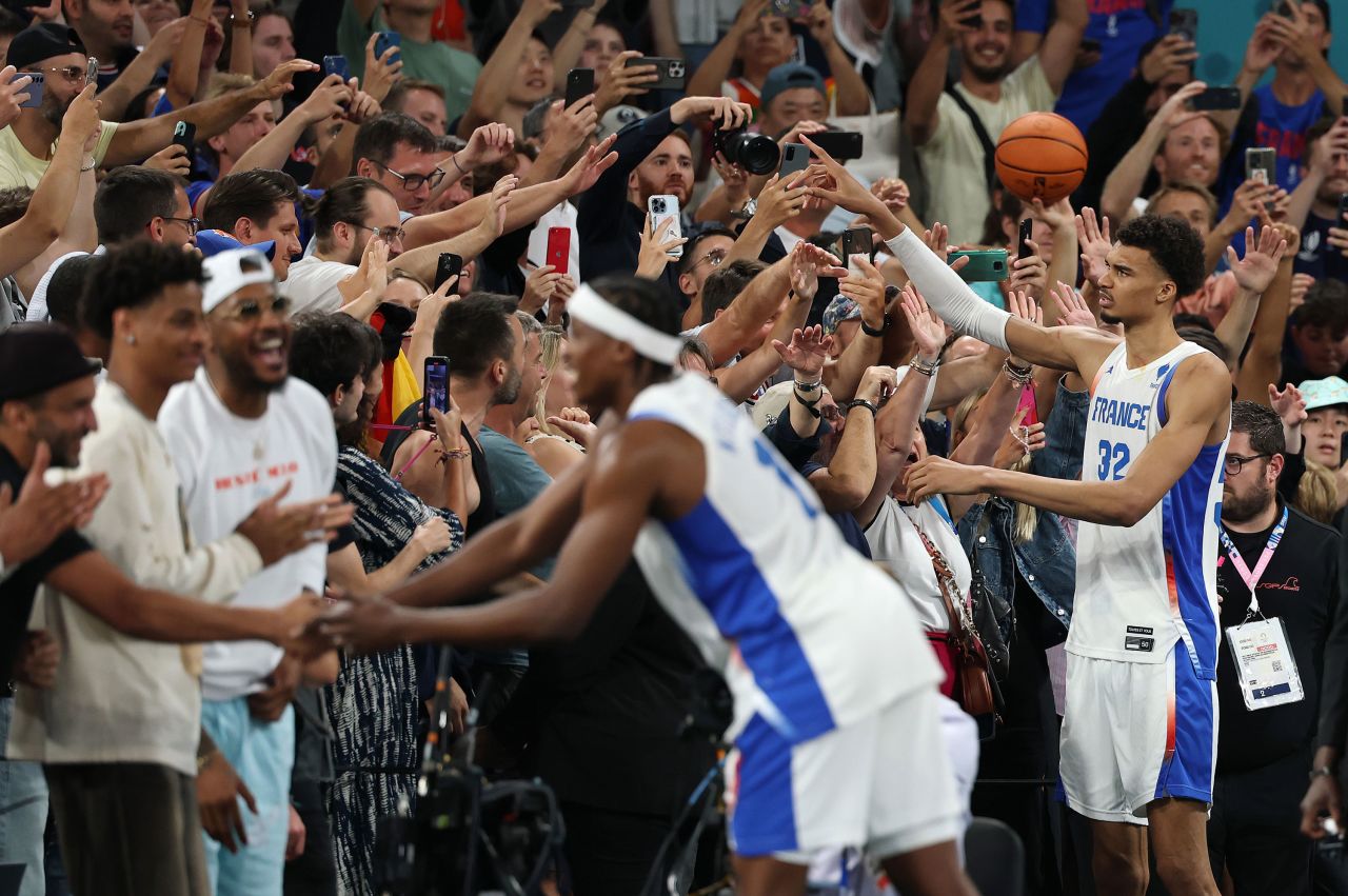 Frank Ntilikina, center, and Victor Wembanyama of France celebrate with fans after their team's win against Germany on Thursday.